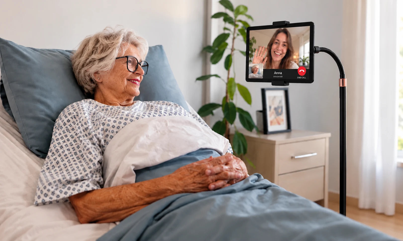Heedy floor tablet stand beside a bed, showing its 176 cm height, flexible arm, 360-degree rotation, secure tablet grip and stable non-slip base.