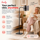 Heedy floor tablet stand with flexible arm positioned beside a chair for comfortable hands-free tablet use at home.