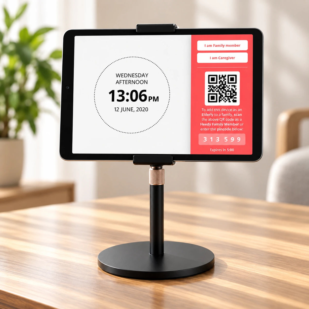 Heedy tablet on an adjustable stand displaying the QR code and connection PIN used to connect a family member’s tablet.