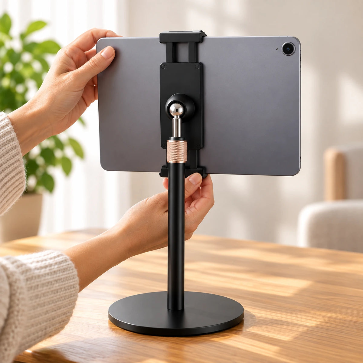 Hands securely mounting a tablet in landscape orientation onto the Heedy adjustable tabletop tablet stand.